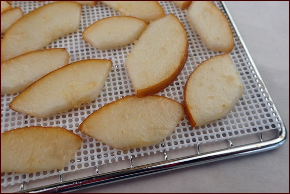 Dehydrating sliced pears on a nonstick mesh sheet.