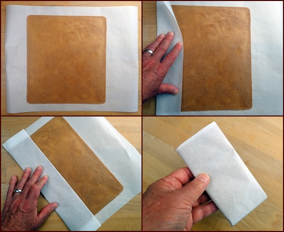Folding pear fruit leather in parchment paper.