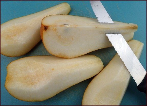 Pears cut into quarters before dehydrating.