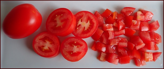 Dicing plum tomatoes for dehydrating.