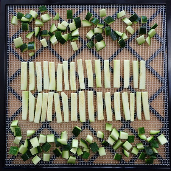Zucchini noodles and skins on dehydrator tray.