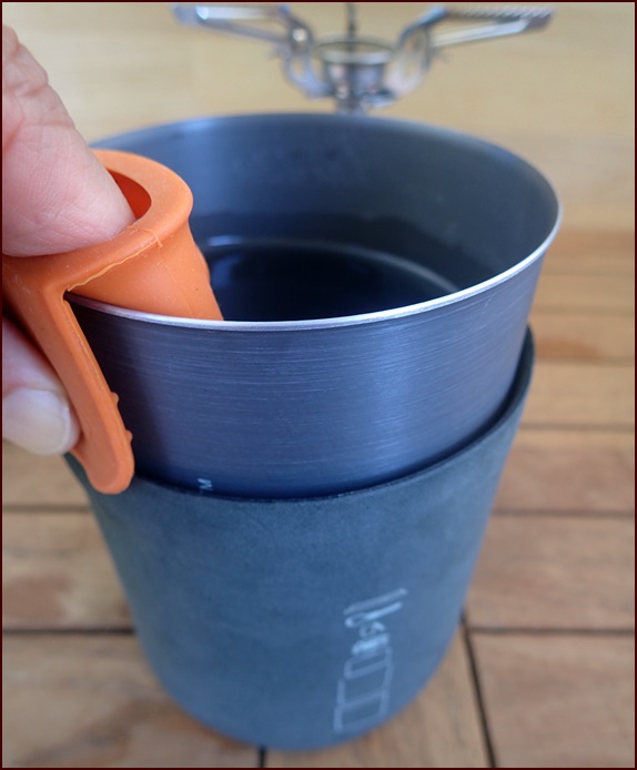 Sliding the pot into the cozy after removing the pot from the stove.