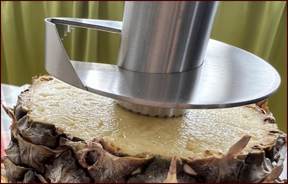 Aligning pineapple corer over core.