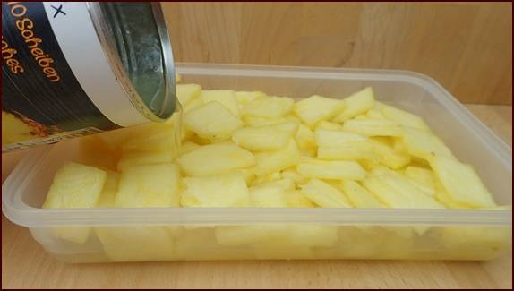 Soaking cut pineapple in juice.